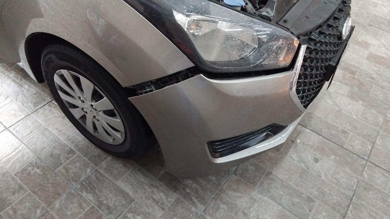 Para-choque dianteiro amassado, foto real de cliente na oficina